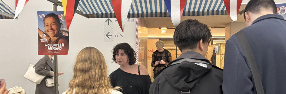 A UvA staff member is standing by at a booth to answer questions